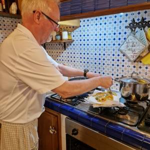 a man cooking in a kitchen preparing food