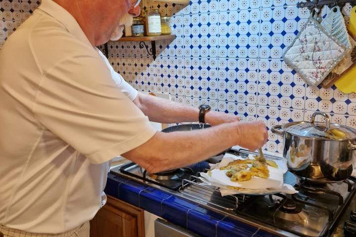 a man cooking in a kitchen preparing food