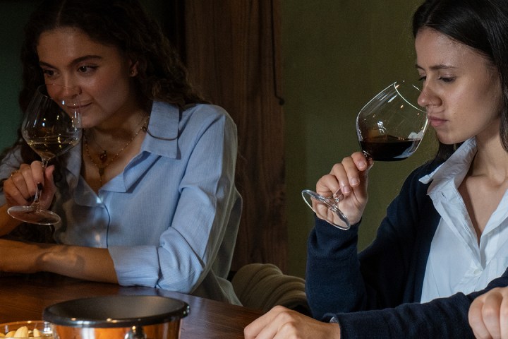 a group of people sitting at a table drinking wine