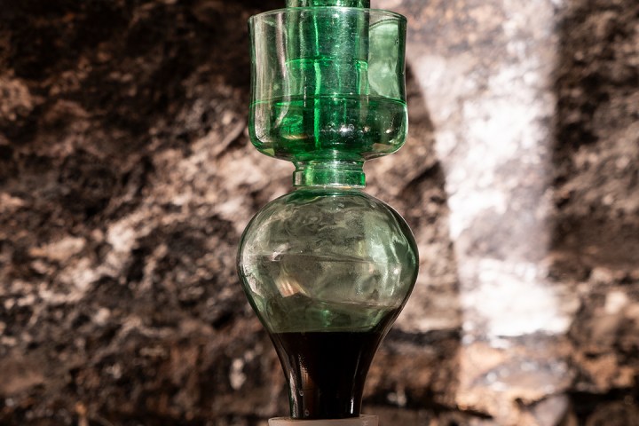 a bottle of wine sitting on top of a wooden table