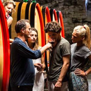 a group of people standing on top of a surfboard