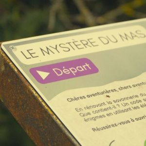 Close-up of a sign titled 'Le Mystère du Mas' with a purple 'Départ' button.