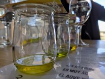Small glass jars with olive oil on a table, with blurred background.