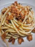 Close-up of pasta with breadcrumbs on a plate.
