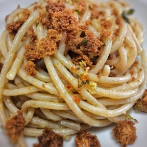 Close-up of pasta with breadcrumbs on a plate.