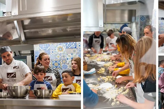 People of various ages cooking together in a kitchen with colorful tiled walls.