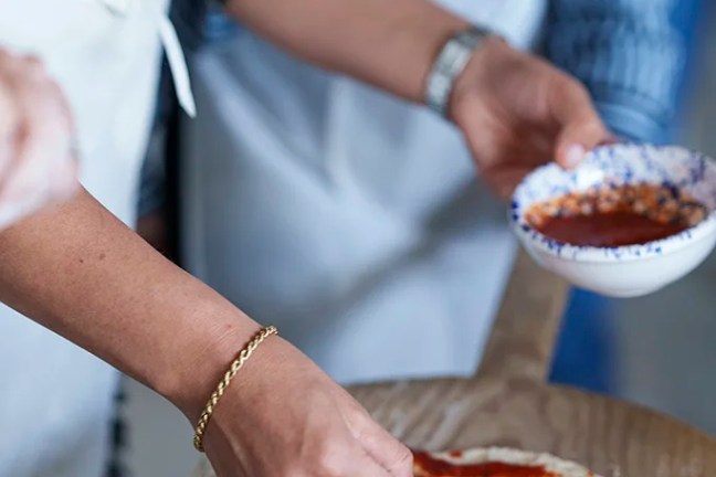 Hands preparing traditional Neapolitan pizza dough