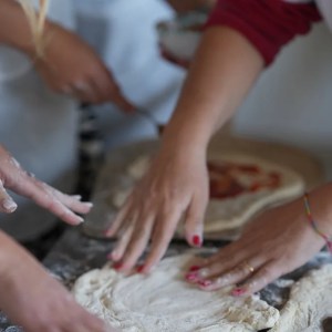 Hands preparing traditional Neapolitan pizza dough