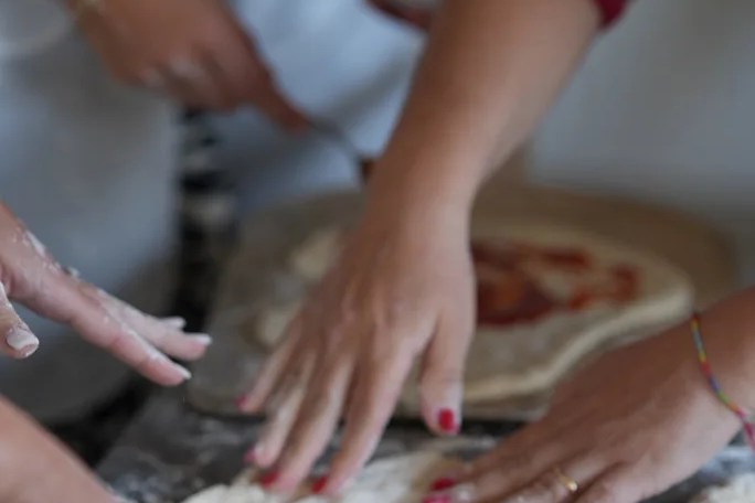 Hands preparing traditional Neapolitan pizza dough