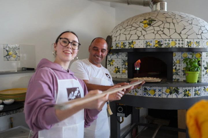 Wood-fired oven baking Margherita pizza in Italy