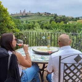 Panoramic view of San Gimignano's medieval towers from a winery terrace