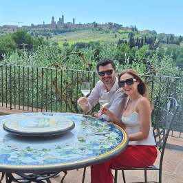 Wine glasses filled with Vernaccia di San Gimignano DOCG with medieval towers in the background