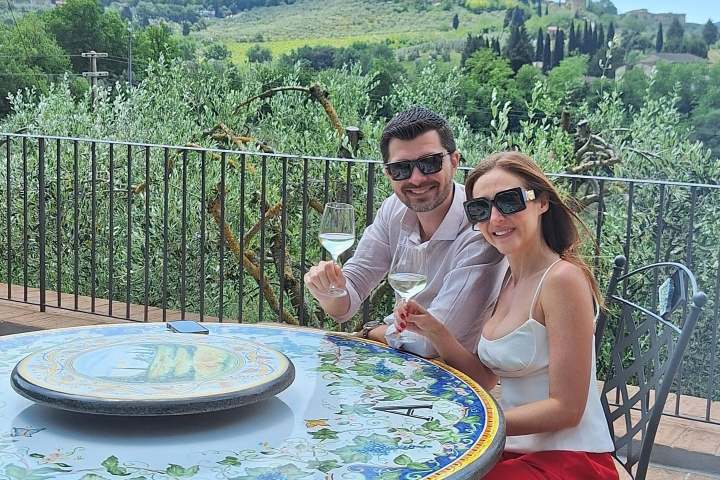 Wine glasses filled with Vernaccia di San Gimignano DOCG with medieval towers in the background