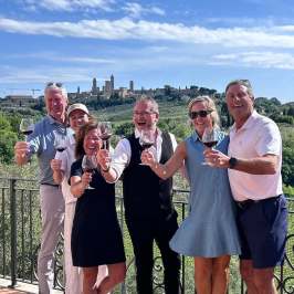 Wine glasses filled with Vernaccia di San Gimignano DOCG with medieval towers in the background