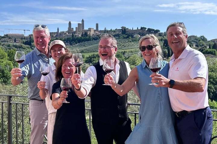 Wine glasses filled with Vernaccia di San Gimignano DOCG with medieval towers in the background