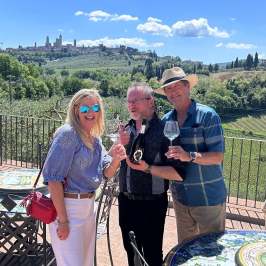 Wine glasses filled with Vernaccia di San Gimignano DOCG with medieval towers in the background