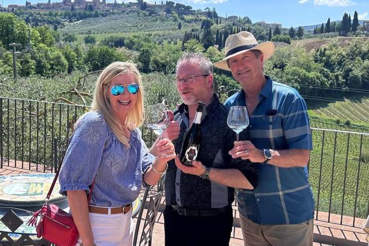 Wine glasses filled with Vernaccia di San Gimignano DOCG with medieval towers in the background