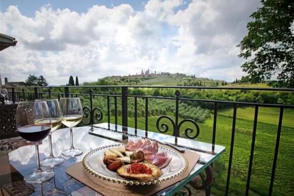 Tuscan wine tasting spread with cheeses, salami, and bruschetta in San Gimignano