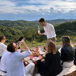 Golden hour view over Monferrato vineyards during wine picnic