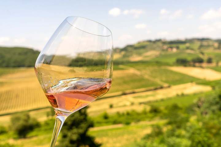 Golden Vin Santo wine poured into a glass in San Gimignano
