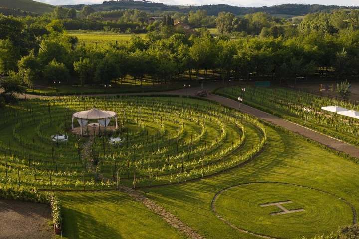 Aerial view of a circular garden maze with a central gazebo.