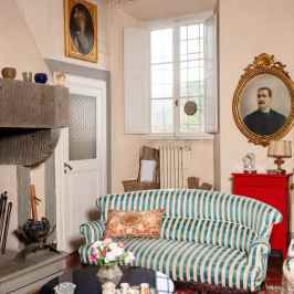 Antique salon with striped sofa and portraits in a Tuscan villa