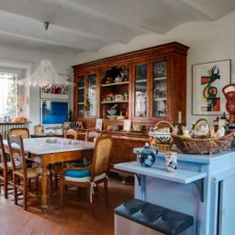 Rustic Tuscan farmhouse kitchen with wooden dresser and dining table